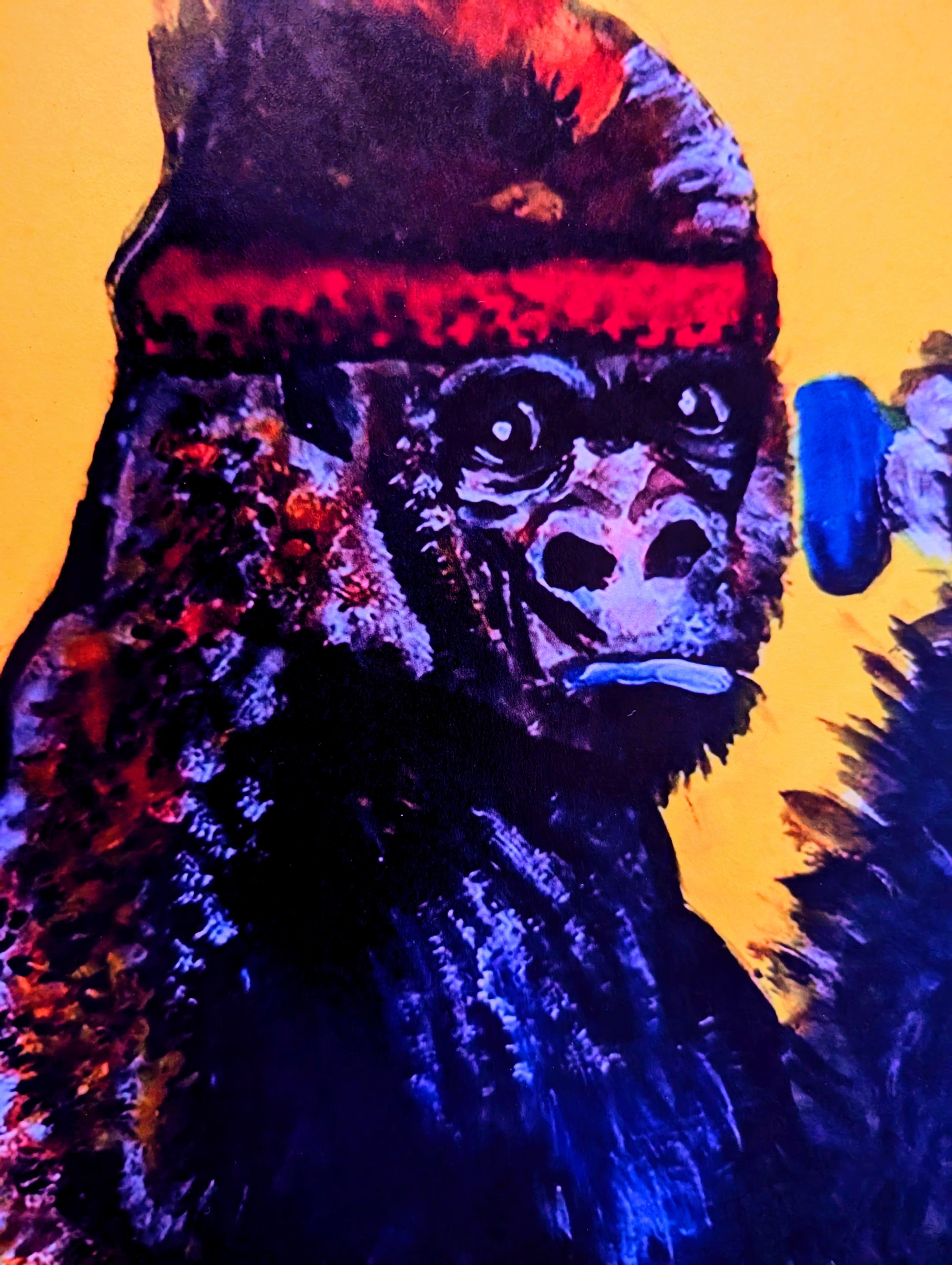 Colorful gorilla illustration with a red headband on a yellow background