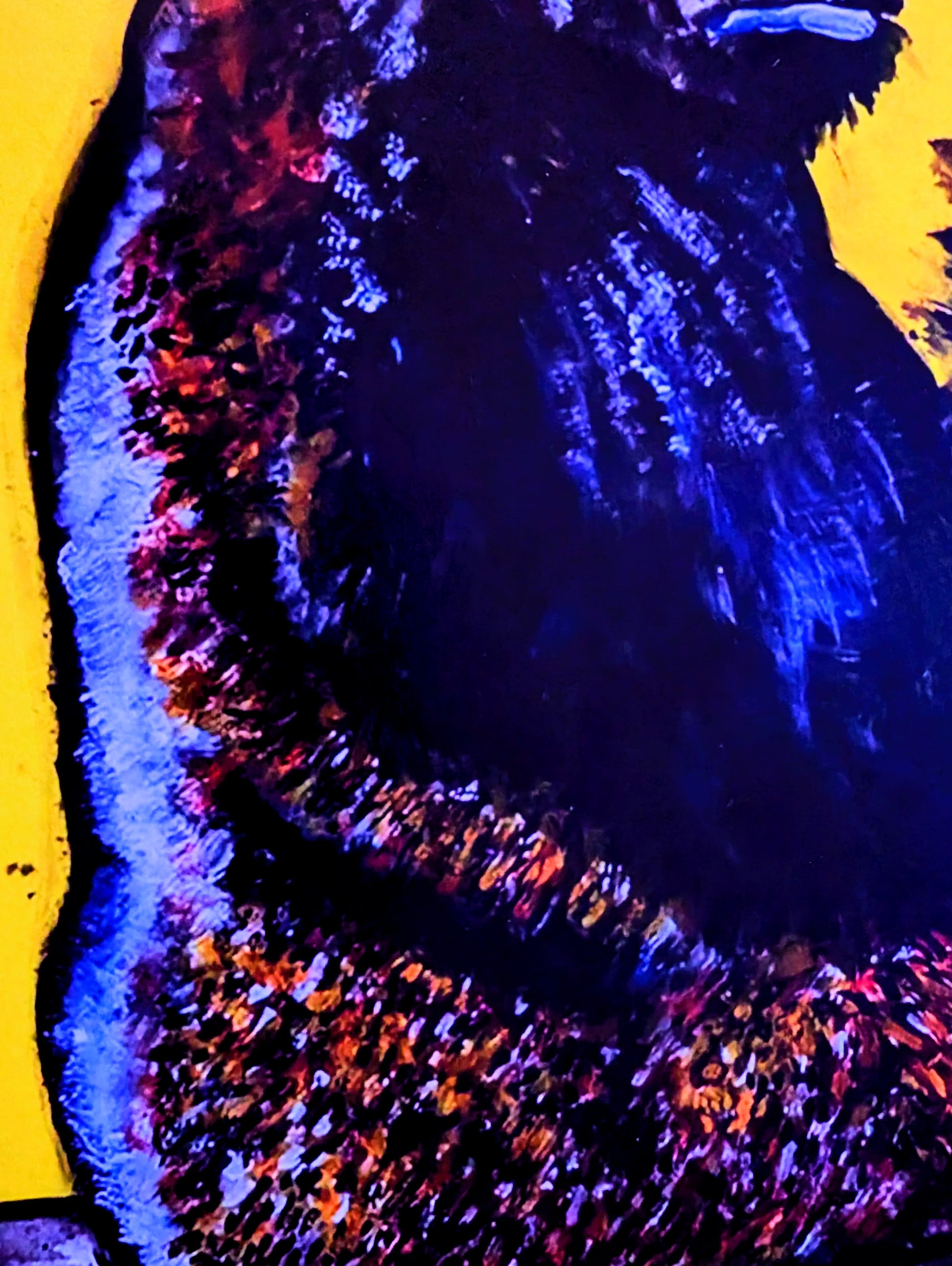 Close-up of a textured surface with blue and purple colors on a yellow background